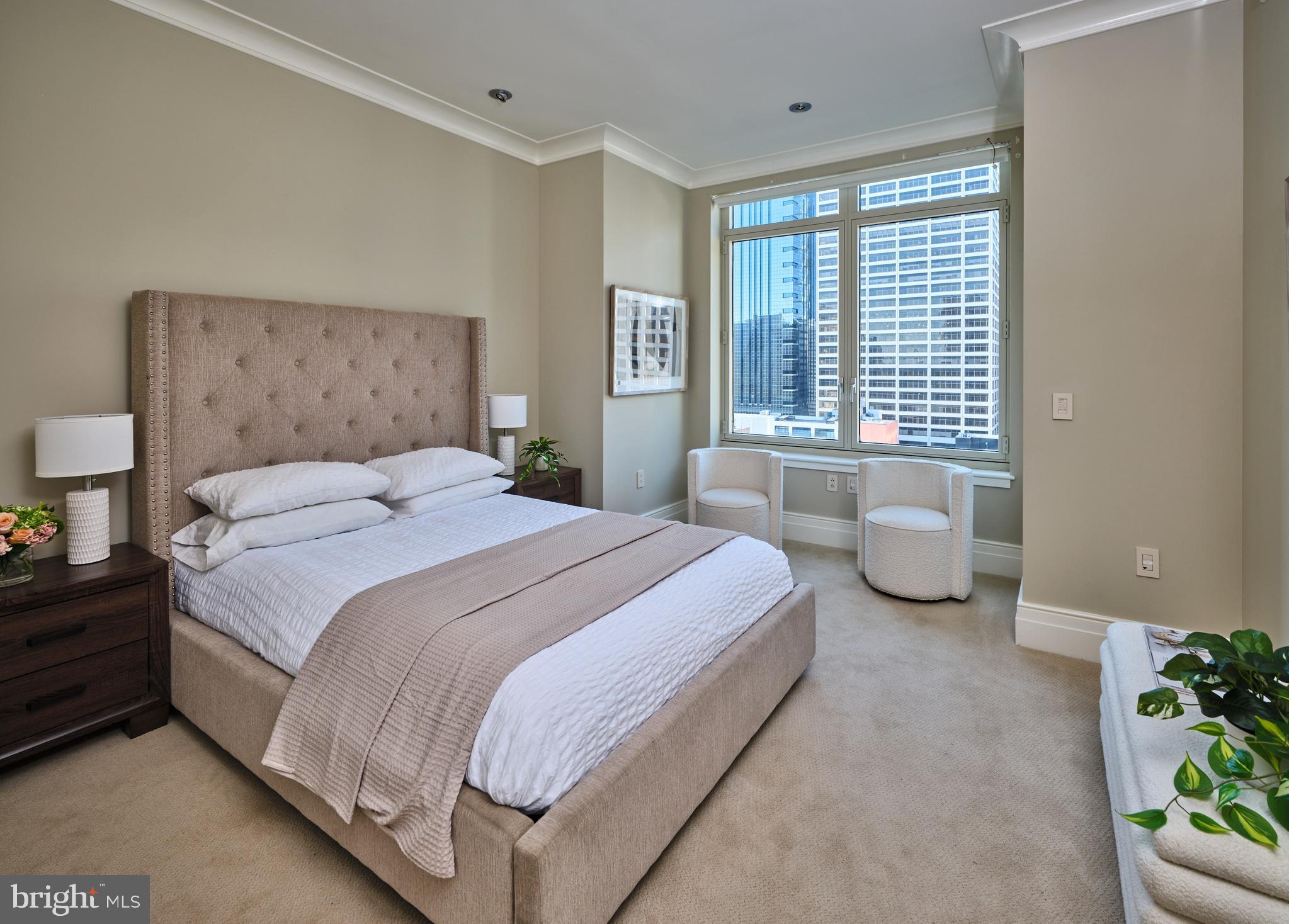 130 South 18th Street, Unit 1602 Philadelphia, PA 19103 - Photo 27 of 52 a spacious bedroom with a bed and a window