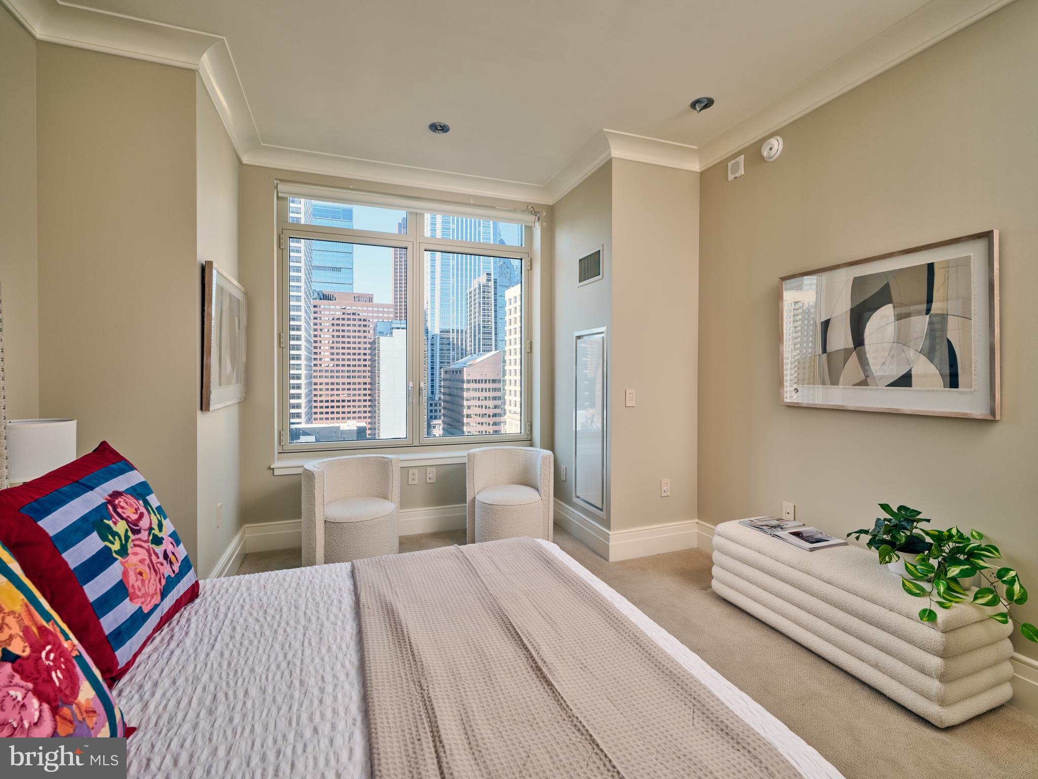 130 South 18th Street, Unit 1602 Philadelphia, PA 19103 - Photo 28 of 52 a bedroom with a bed and a large window with the outer view