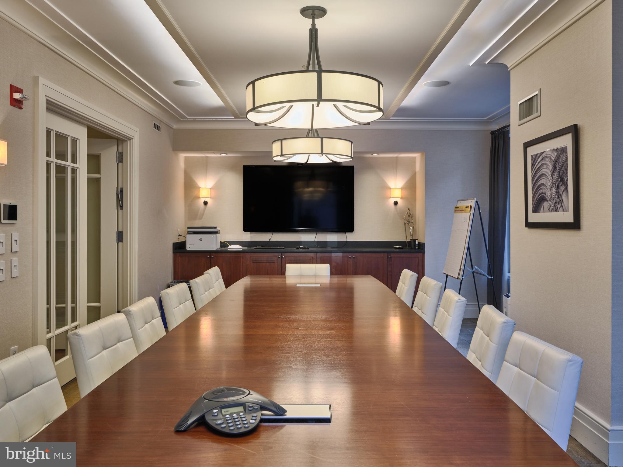 130 South 18th Street, Unit 1602 Philadelphia, PA 19103 - Photo 47 of 52 a view of a dining room with furniture a chandelier and wooden floor