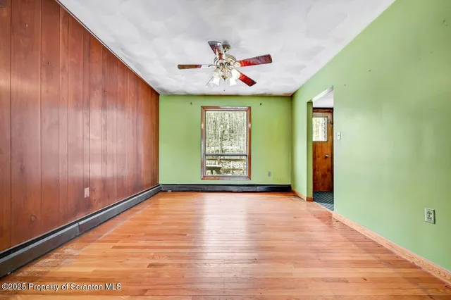 a view of an empty room with window and cabinet