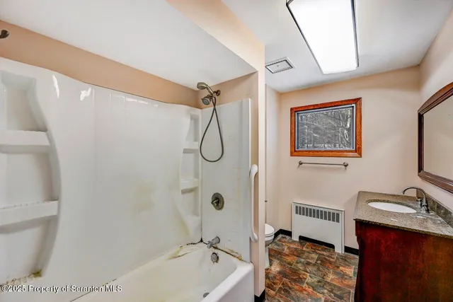 a bathroom with a sink a mirror and a shower