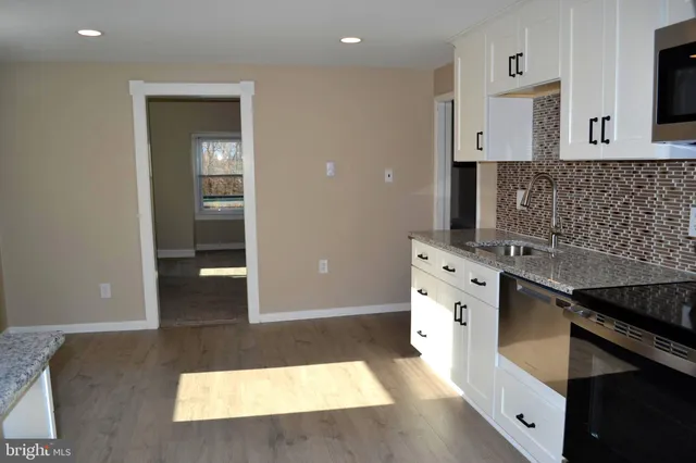 a kitchen with stainless steel appliances granite countertop a stove and a sink