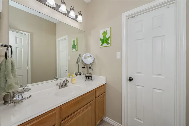 a bathroom with a sink vanity and a mirror