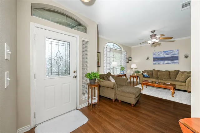 a living room with furniture and wooden floor