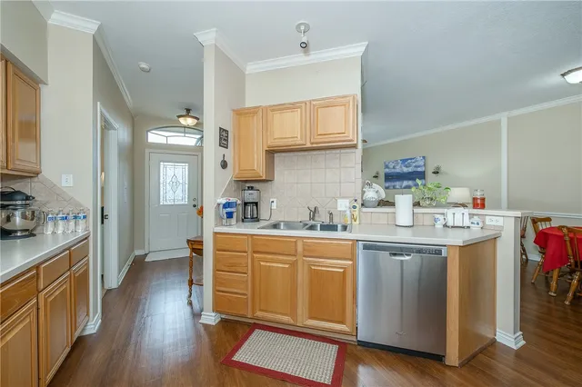 a kitchen with a sink cabinets and wooden floor