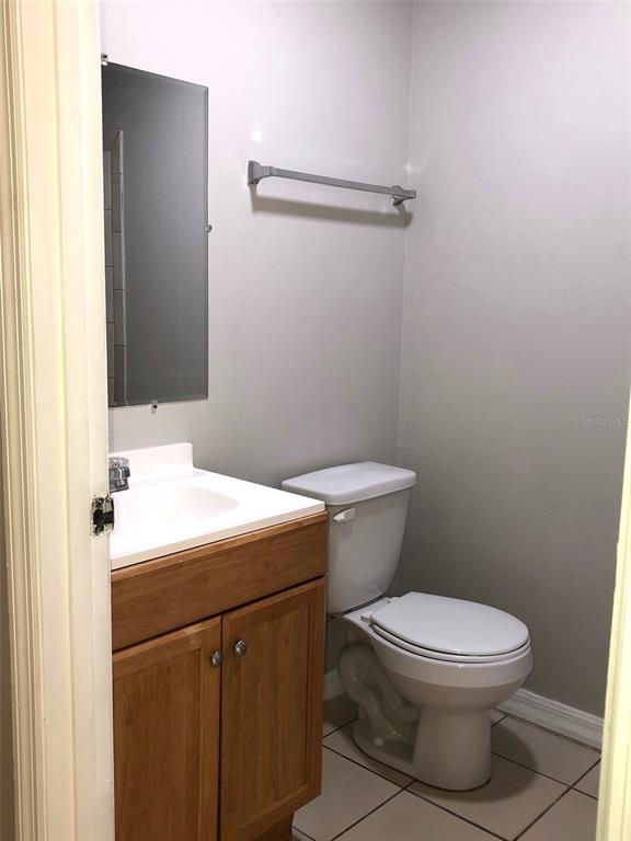 2406 South Maple Avenue Sanford, FL 32771 - Photo 5 of 12 a bathroom with a sink a toilet and a mirror