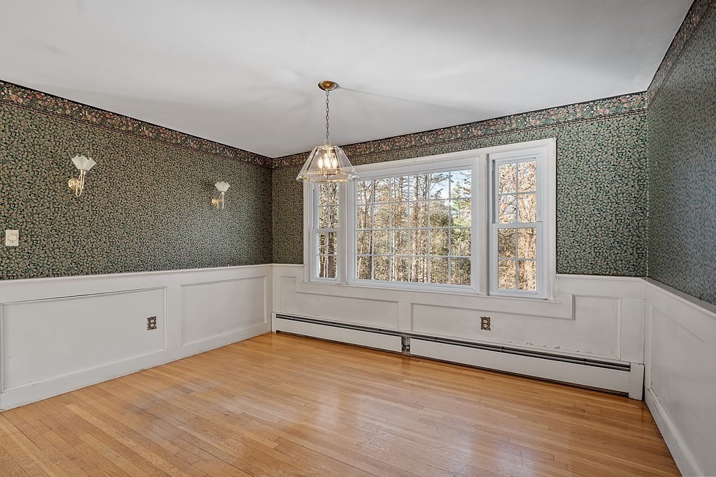 185 Sterling Road Lancaster, MA 01523 - Photo 14 of 42 a view of an empty room with a window and wooden floor