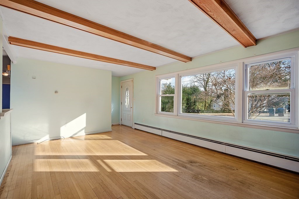 185 Sterling Road Lancaster, MA 01523 - Photo 18 of 42 a view of an empty room with wooden floor and a window