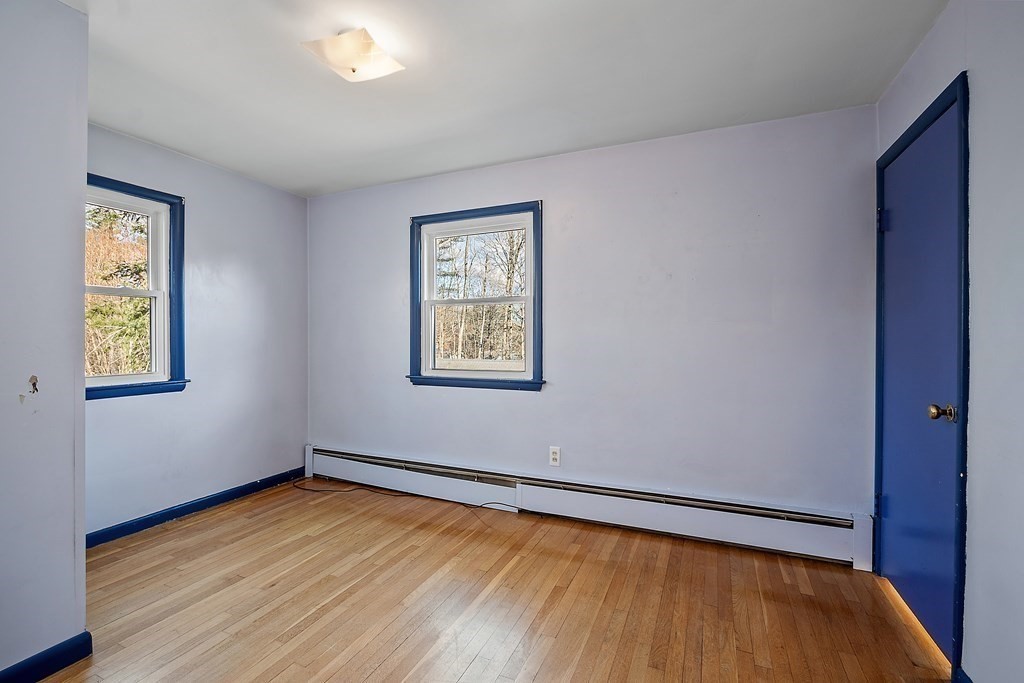185 Sterling Road Lancaster, MA 01523 - Photo 19 of 42 a view of empty room with wooden floor and fan