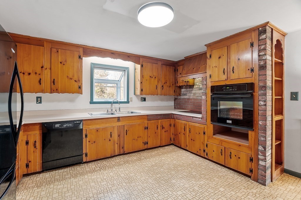 185 Sterling Road Lancaster, MA 01523 - Photo 10 of 42 a large kitchen with stainless steel appliances granite countertop a stove and a sink