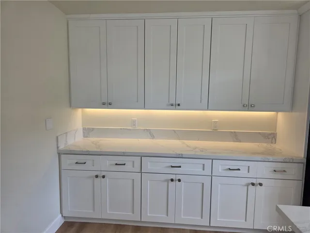 a view of kitchen with white cabinets