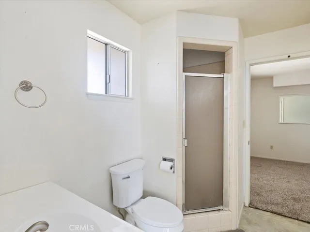 a white toilet sitting next to a bathroom sink