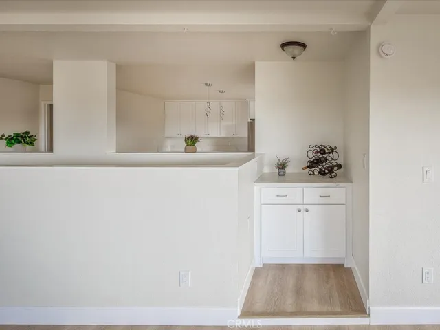 a room with white cabinets and white appliances