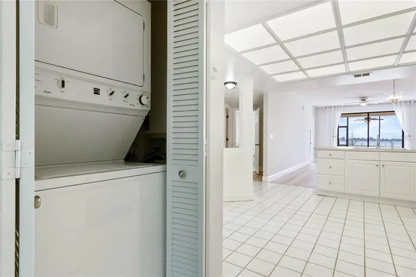 a view of a hallway with bathroom and mirror