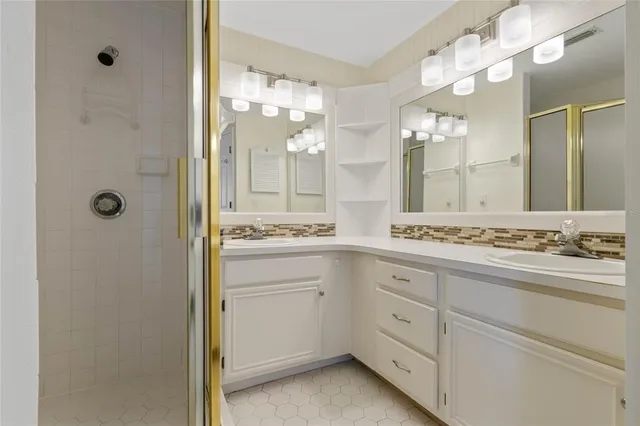 a bathroom with a double vanity sink and mirror