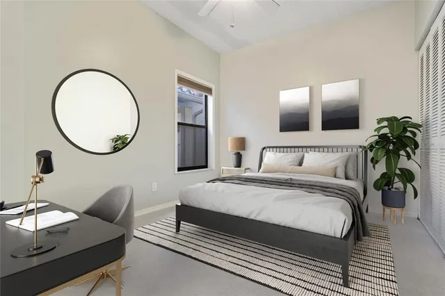 a bedroom with bed and a mirror