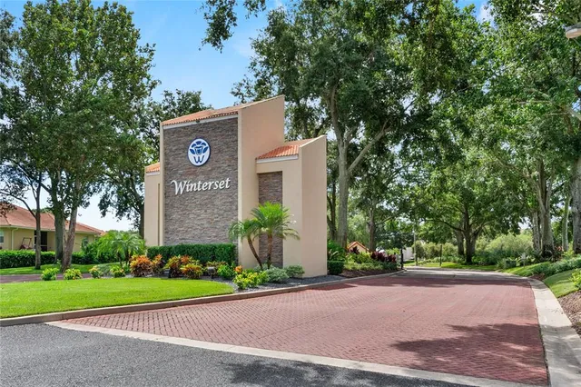 a front view of a house with a yard and a garage