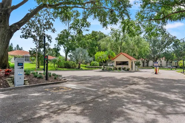 a front view of a house with a yard and tree s