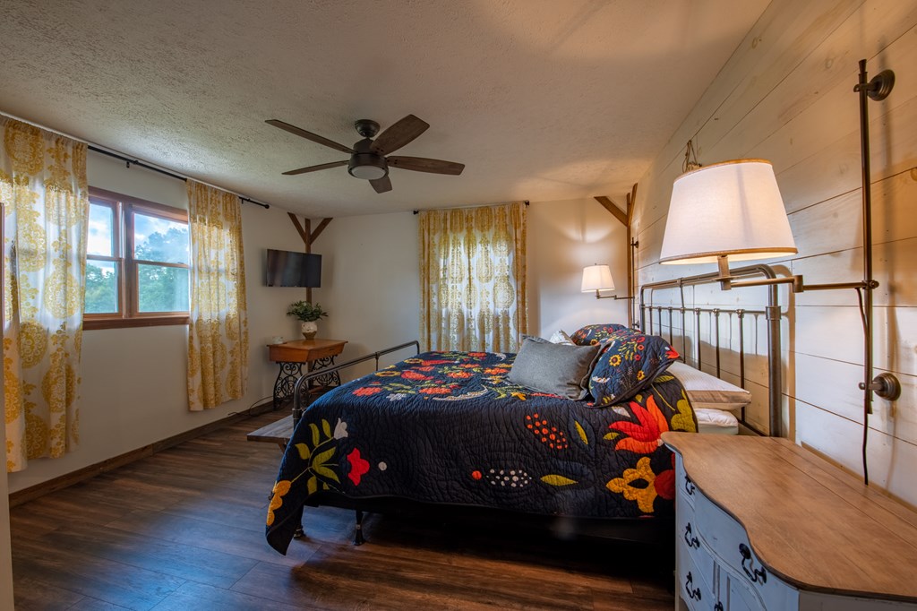 588 Pinetree Road Blue Ridge, GA 30513 - Photo 17 of 54 a bedroom with furniture and a window