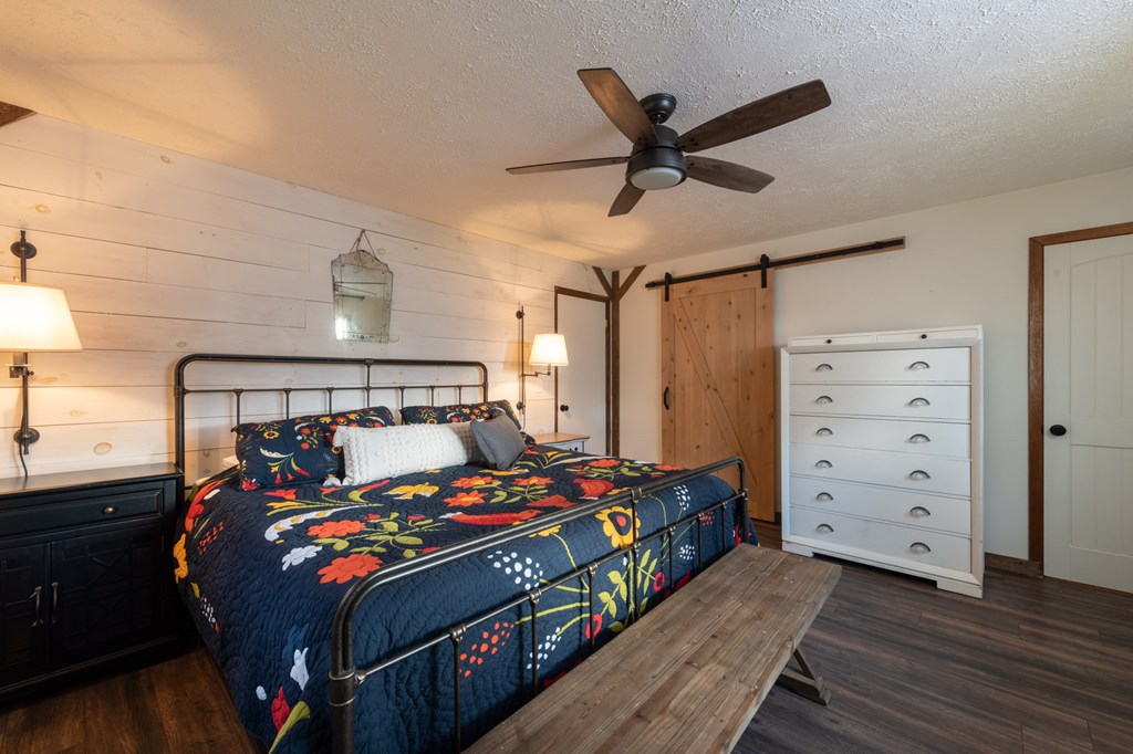 588 Pinetree Road Blue Ridge, GA 30513 - Photo 18 of 54 a bedroom with a bed and a ceiling fan