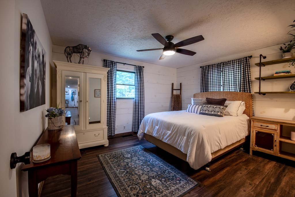 588 Pinetree Road Blue Ridge, GA 30513 - Photo 22 of 54 a bedroom with a bed and wooden floor