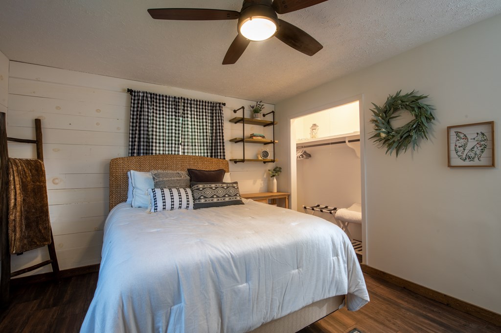 588 Pinetree Road Blue Ridge, GA 30513 - Photo 23 of 54 a bedroom with a bed and a chandelier