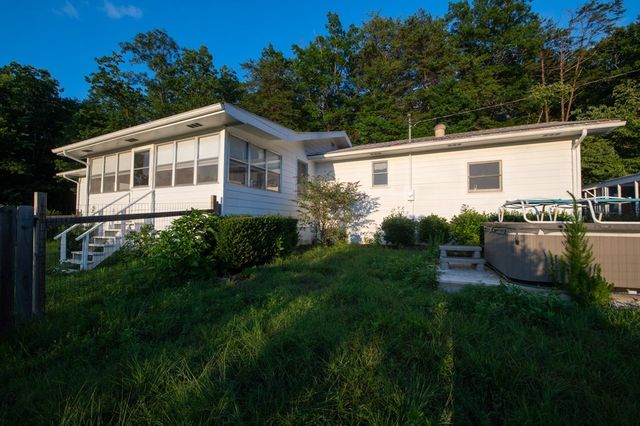 a backyard of a house with lots of green space and trees