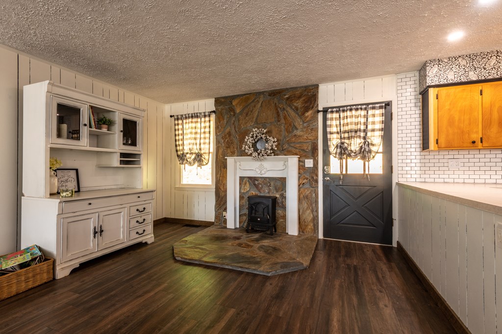588 Pinetree Road Blue Ridge, GA 30513 - Photo 6 of 54 a living room with stainless steel appliances granite countertop a fireplace and wooden floors