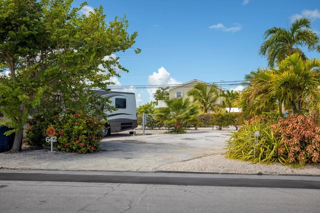 a front view of a house with a yard and a garage