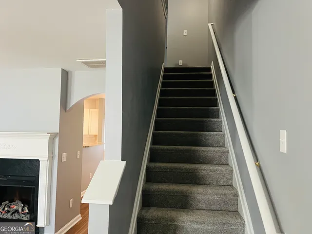 a view of entryway and hall with wooden floor