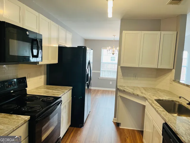 a kitchen with a refrigerator stove and sink