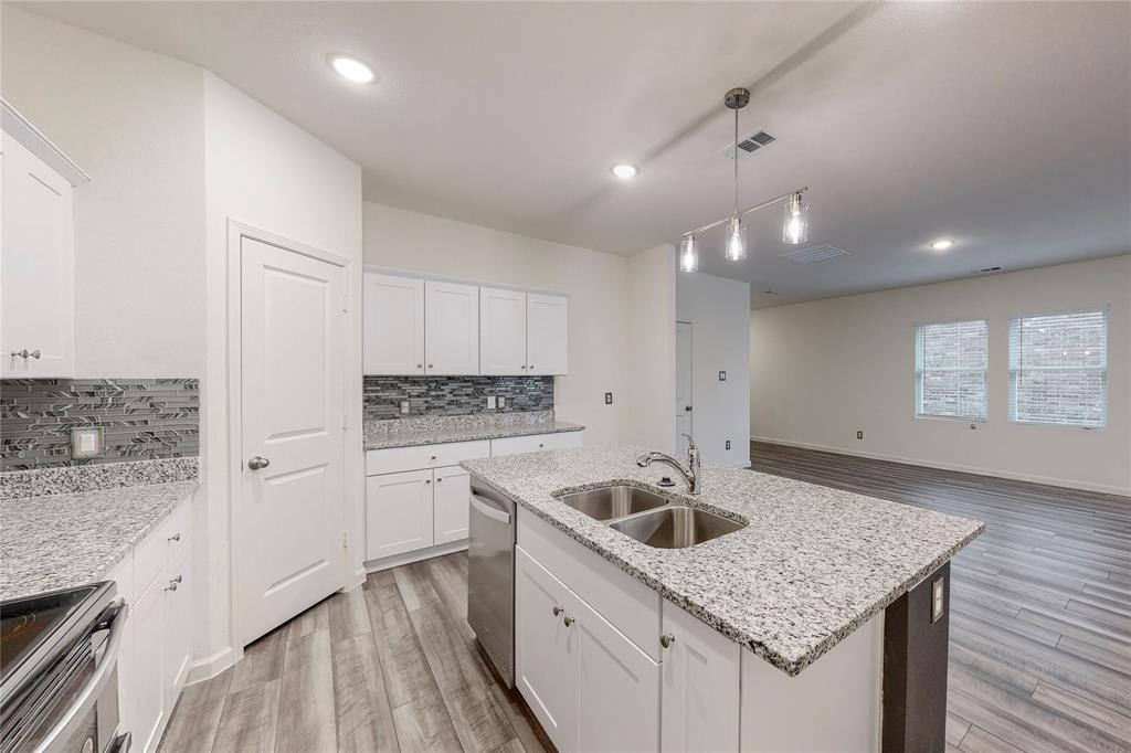417 Madison Way Princeton, TX 75407 - Photo 12 of 40 Kitchen featuring white cabinetry, light wood-type flooring, stainless steel appliances, pendant lighting, and recessed lighting