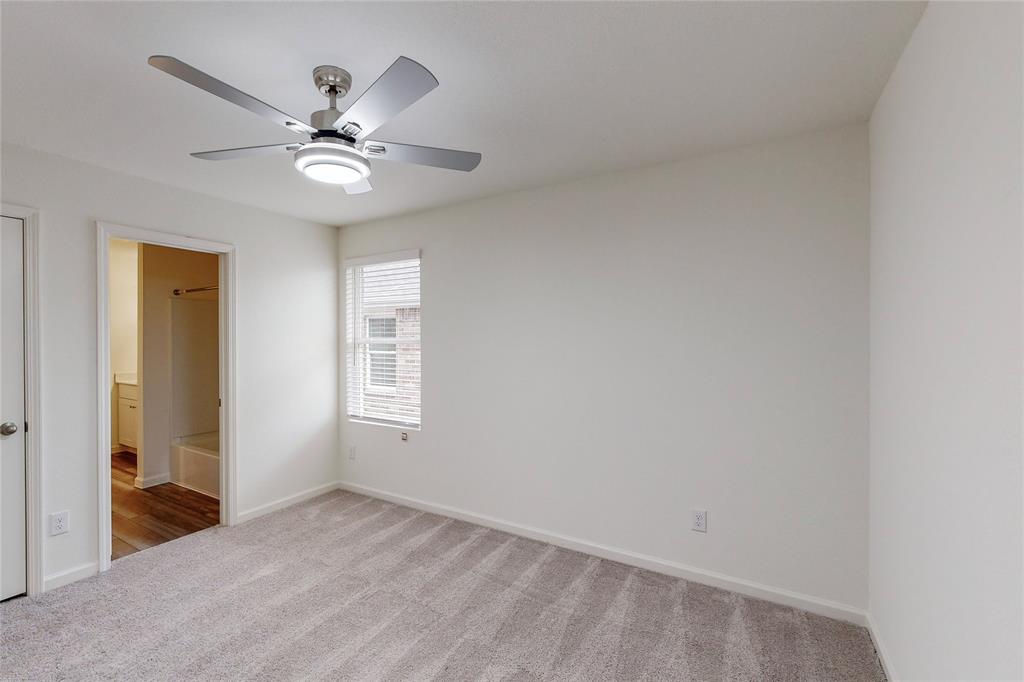 417 Madison Way Princeton, TX 75407 - Photo 18 of 40 Unfurnished bedroom featuring light colored carpet, a ceiling fan, and connected bathroom