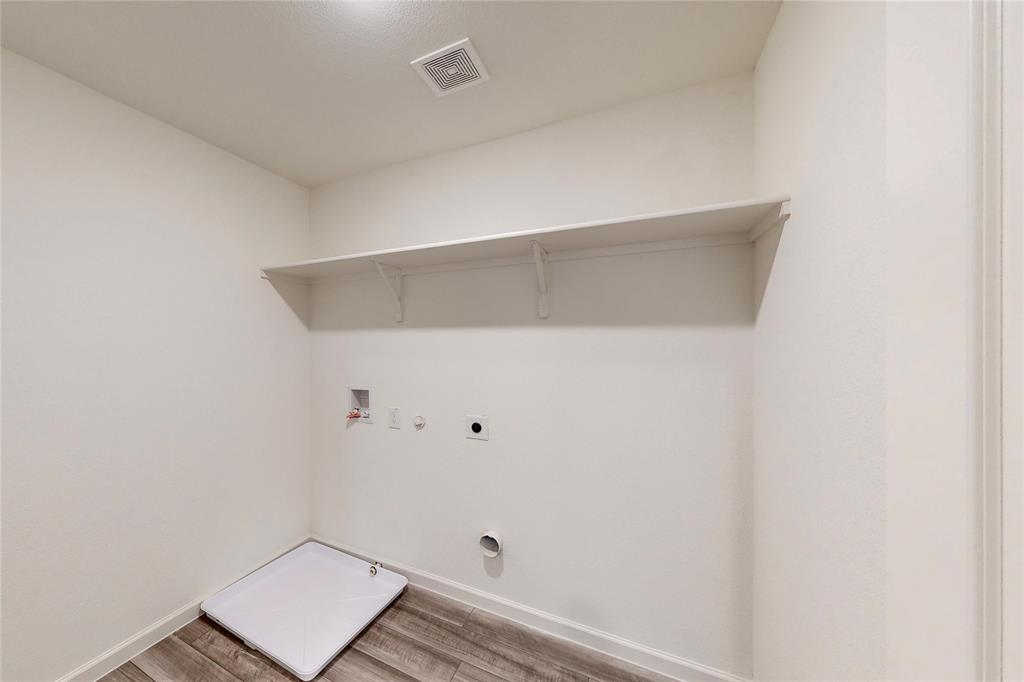 417 Madison Way Princeton, TX 75407 - Photo 23 of 40 Washroom with hookup for a gas dryer, light wood-style floors, washer hookup, and electric dryer hookup