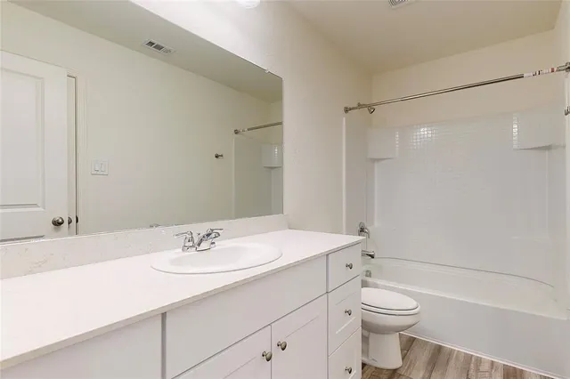 a bathroom with a double vanity sink and mirror