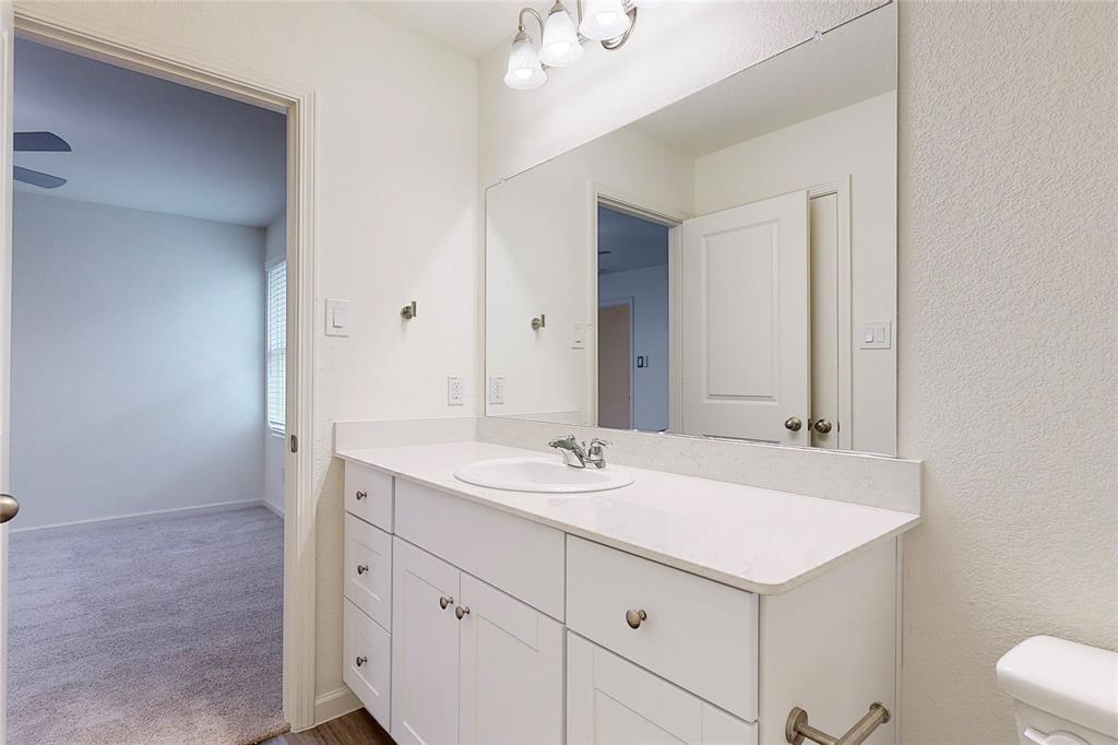 417 Madison Way Princeton, TX 75407 - Photo 36 of 40 Bathroom with vanity, a chandelier, and dark colored carpet