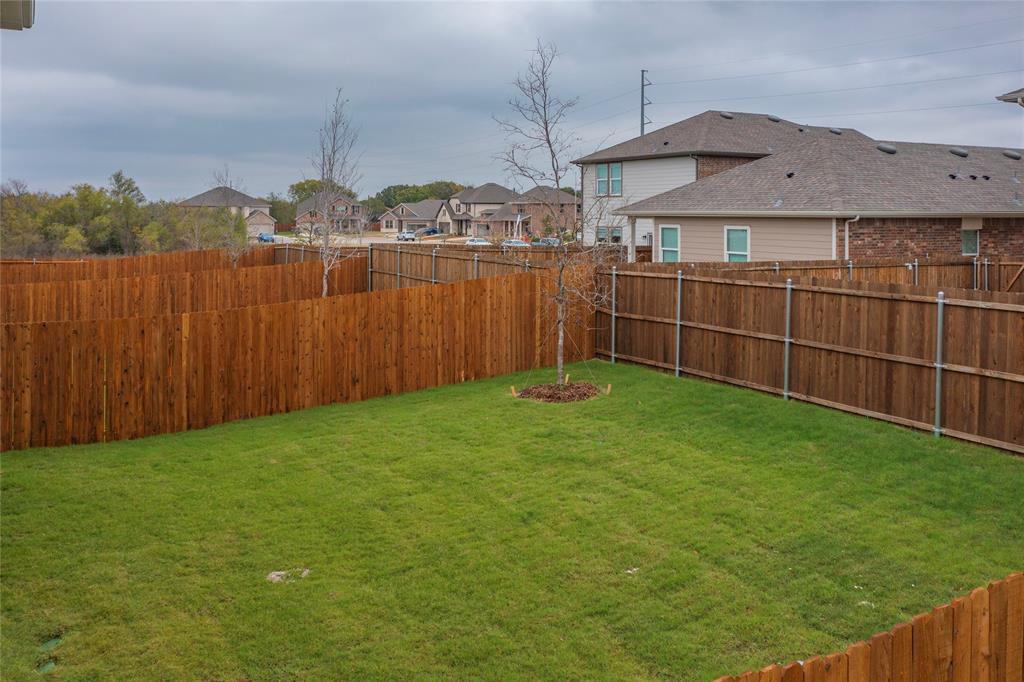 417 Madison Way Princeton, TX 75407 - Photo 37 of 40 Fenced backyard with a residential view