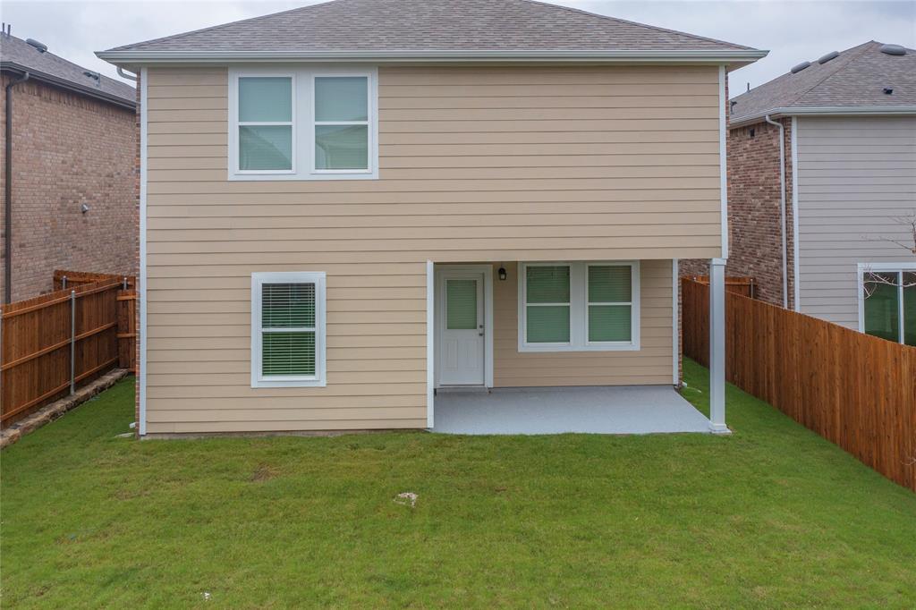 417 Madison Way Princeton, TX 75407 - Photo 4 of 40 Back of house with a patio area, roof with shingles, and a fenced backyard