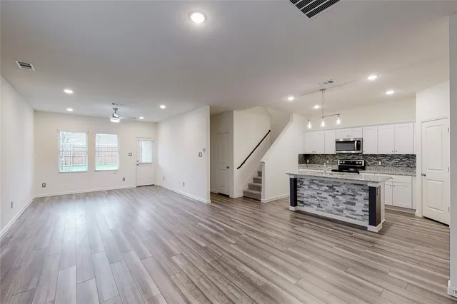 a view of kitchen with sink and wooden floor