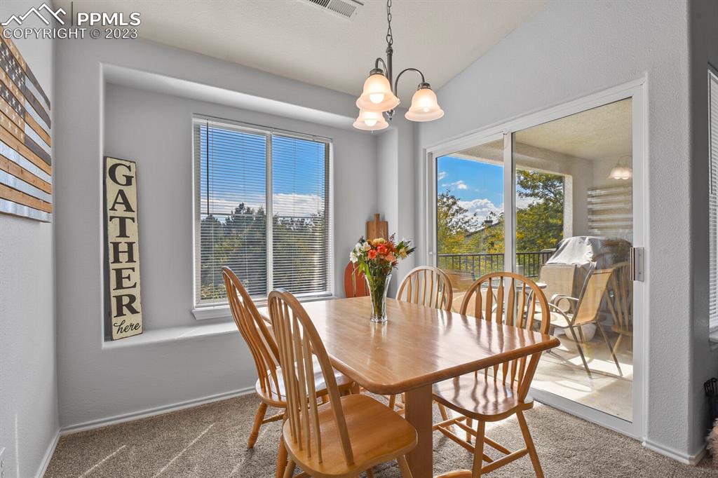 3960 Riviera Grove, Unit 204 Colorado Springs, CO 80922 - Photo 12 of 25 a view of a dining room with furniture window and outside view