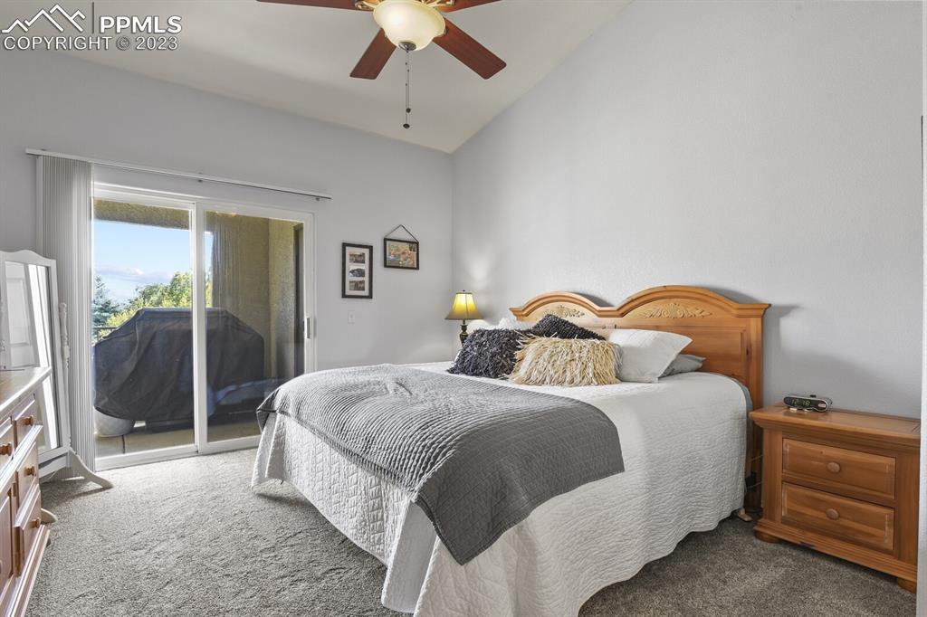 3960 Riviera Grove, Unit 204 Colorado Springs, CO 80922 - Photo 14 of 25 a bedroom with a bed and a chandelier