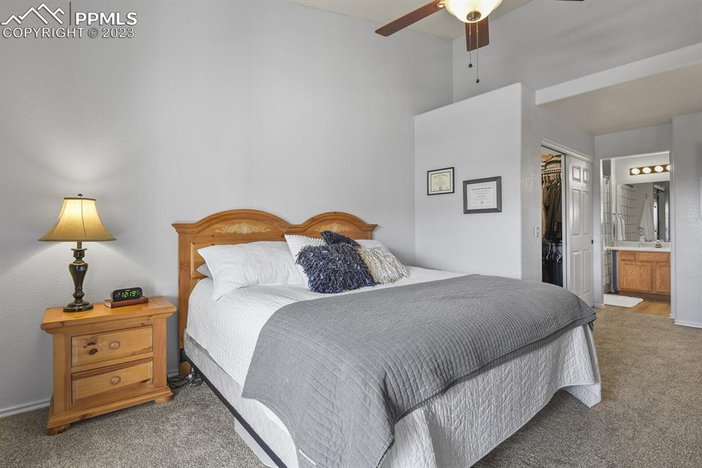 3960 Riviera Grove, Unit 204 Colorado Springs, CO 80922 - Photo 15 of 25 a bedroom with a bed and a lamp on a dresser
