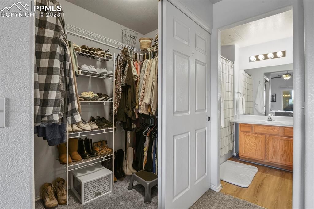 3960 Riviera Grove, Unit 204 Colorado Springs, CO 80922 - Photo 17 of 25 a view of walk in closet with clothes and shoes