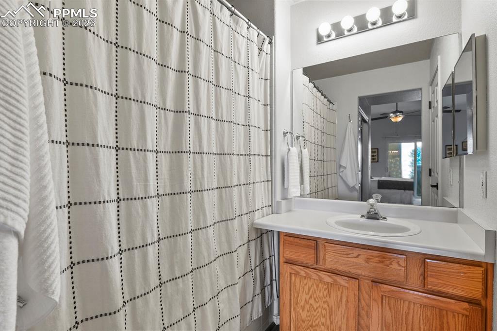 3960 Riviera Grove, Unit 204 Colorado Springs, CO 80922 - Photo 18 of 25 a bathroom with a sink and a mirror