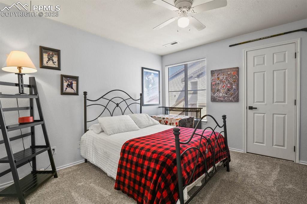 3960 Riviera Grove, Unit 204 Colorado Springs, CO 80922 - Photo 19 of 25 a bedroom with a bed and window