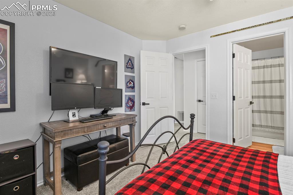 3960 Riviera Grove, Unit 204 Colorado Springs, CO 80922 - Photo 20 of 25 a bedroom with a bed and a dresser