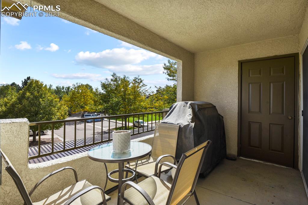 3960 Riviera Grove, Unit 204 Colorado Springs, CO 80922 - Photo 22 of 25 a balcony with table and chairs