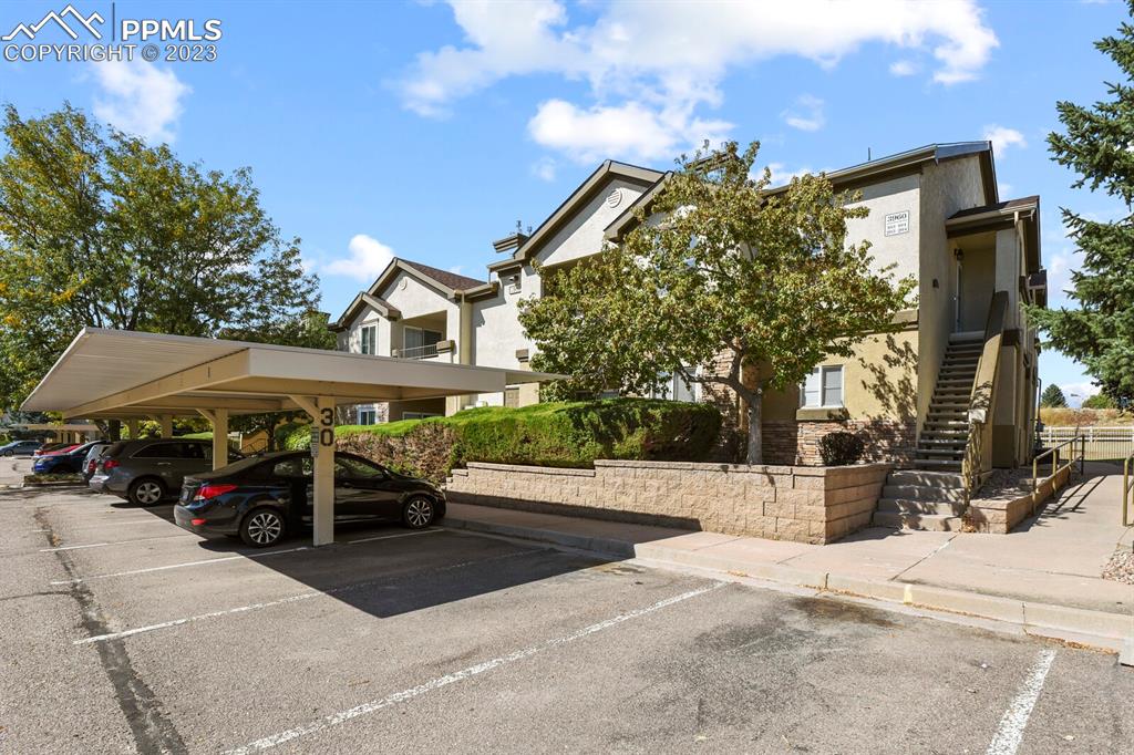 3960 Riviera Grove, Unit 204 Colorado Springs, CO 80922 - Photo 24 of 25 a view of a patio with a table and chairs under an umbrella