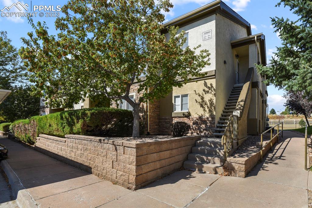 3960 Riviera Grove, Unit 204 Colorado Springs, CO 80922 - Photo 25 of 25 a view of a chairs and tables in the back yard of the house