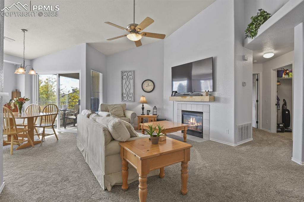 3960 Riviera Grove, Unit 204 Colorado Springs, CO 80922 - Photo 3 of 25 a living room with furniture a fireplace and a large window